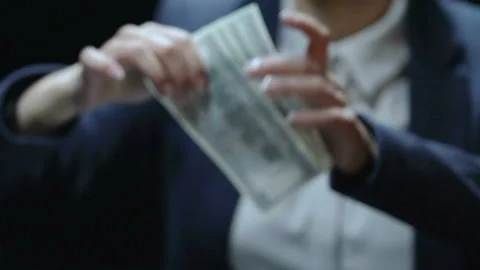 Lady taking dollar bills and putting pocket, bribery transaction, illegal salary 스톡 동영상 88515337