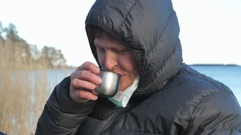 The lady taking off her face mask and drinking in Finland Video stock 129354894