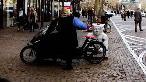 A lady is taking personal bag out of parked Urban Arrow. Stock Footage 152952005
