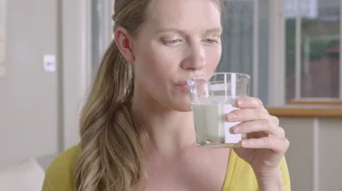 Lady taking a sip of Milk while at home. Stock Footage 63032664