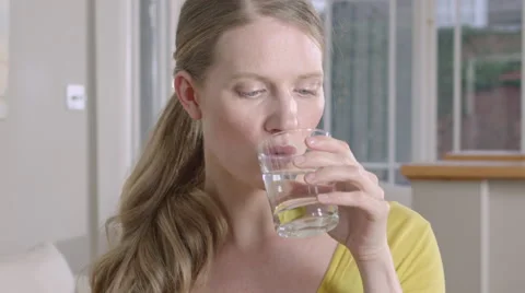 Lady taking a sip of water while at home. Stock Footage 63032647