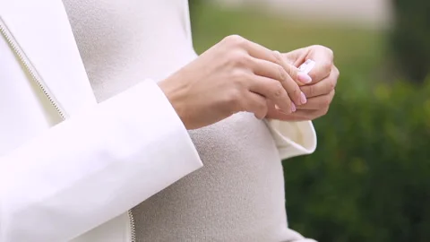 Lady taking vitamins, medication for maintaining pregnancy, early delivery risk Stock Footage 100867623