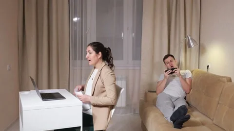 Lady talks on video call and throws paper ball into husband Stock Footage 148361795