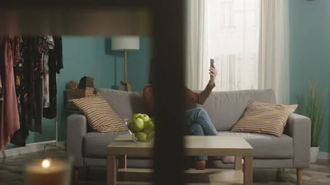 Lady talks on video call and bites red apple Stock Footage 150283079