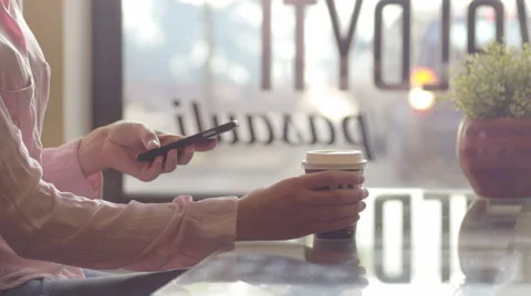 Lady tasting coffee against the window in city cafe Stock Footage 67047692