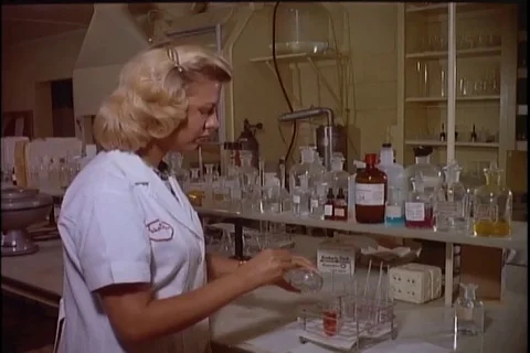 Lady technician make basic acidic solution tests on part of the filter - 1960 Video stock 101167367