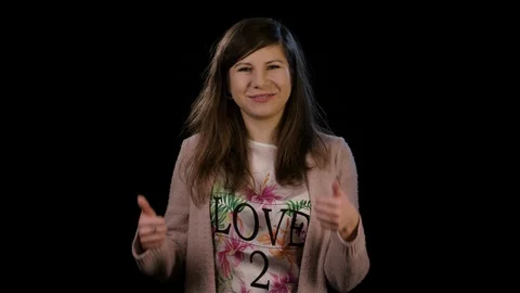 A Lady With Thumbs Up Against a Black Background Stock Footage 86680934