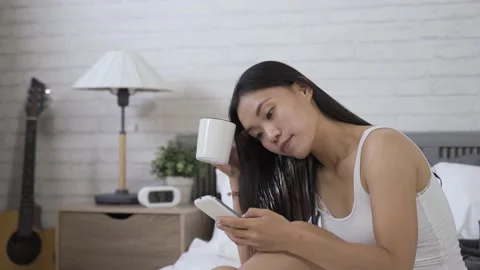 Lady tilting head while browsing phone messages Stock-Footage 154952701
