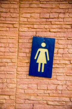 Lady toilet sign on the wall Stock Photos