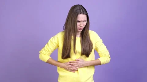 Lady touch tummy suffer sever ulcer pain isolated vibrant color background Video stock 169997843