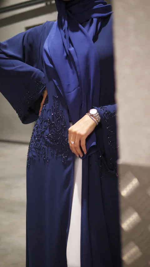 Lady tries on bright chiffon cape shaded white dress standing in hall 動画素材 330189790