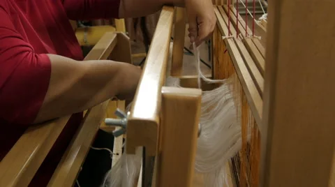 Lady tries white woolen threads through wire of loom, close up. Weaving on loom. Stock Footage 57671929