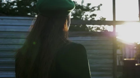 Lady turns head to camera standing against setting sun Video stock 109153909