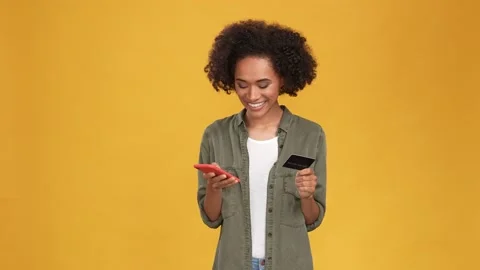 Lady use digital app device debit card store isolated mustard color background Stock Footage 166161643