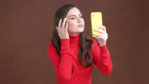 Lady use gadget prepare date look camera isolated brown color background Video stock 189424232