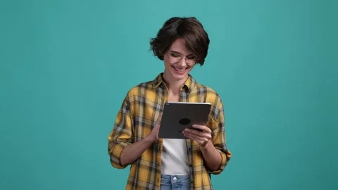 Lady use modern technology searching isolated aquamarine color background Stock Footage 169629553