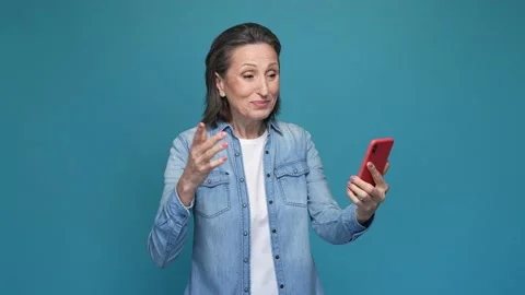 Lady use smart app device shooting vlog isolated blue color background Stock Footage 167321640