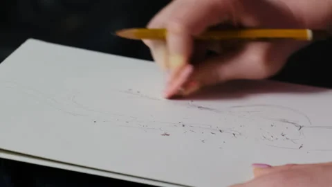 Lady uses small eraser to delete pencil drawing on paper Stock Footage 316142382