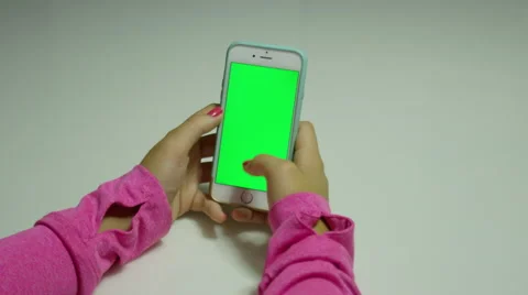 Lady using a cellphone modern technology with green background for chroma.  Stock Footage 68500906