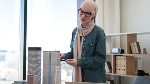 Lady using compass and laptop in architecture office Stock Footage 238045657