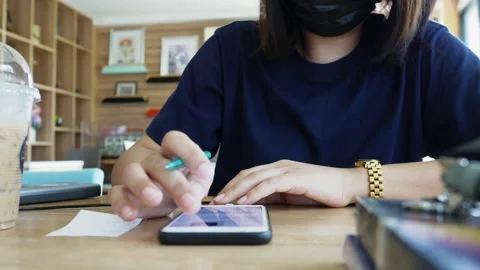 Lady using a mobile phone to calculate Stock Footage 153795125