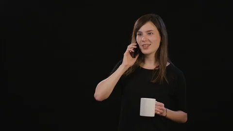 A Lady Using a Phone Against a Black Background 스톡 동영상 87169429