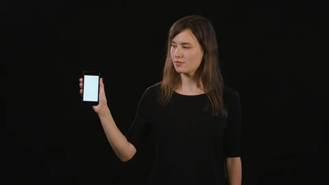 A Lady Using a Phone Against a Black Background Stock Footage 87172074