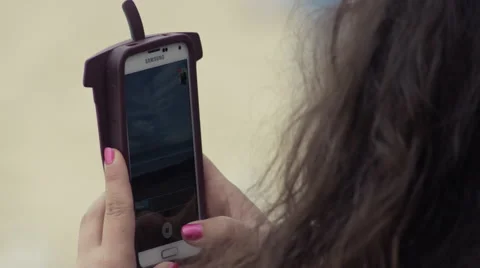 Lady using Samsung smart phone outside Stock Footage 65375533