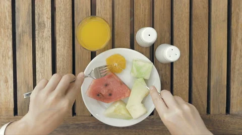 Lady is using utensils to cut meal in small bites 스톡 동영상 65560750