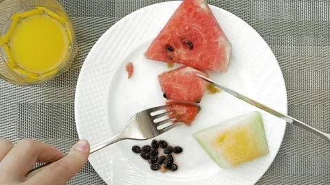 Lady is using utensils to cut meal in small bites Stock Footage 70001004