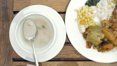 Lady is using utensils to cut meal in small bites Stock Footage 91186593