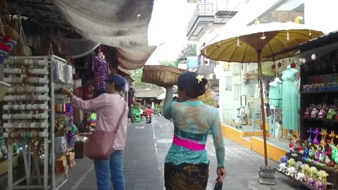 Lady Vendor walking through local Market in Bali, Indonesia Stock Footage 131154334
