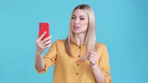 Lady vlogger use gadget live stream broadcast isolated blue color background Stock Footage 170773964