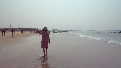 Lady walking along Malpe beach in Karnataka, South India Stock Footage 155012740