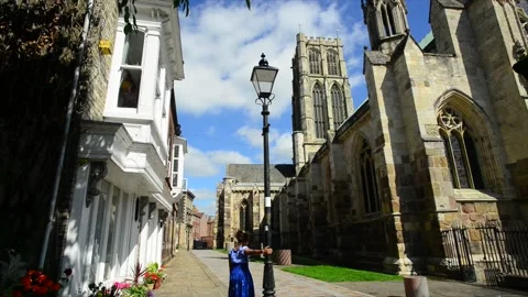 Lady walking by Howden Minster in summertime Yorkshire United Kingdom Stock Footage 159207658