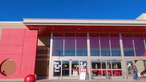 Lady walking out of Target with a face mask on during the covid-19 pandemic Stock Footage 143441736