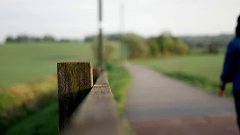 Lady walking on a pathway in a park Stock Footage 107599190