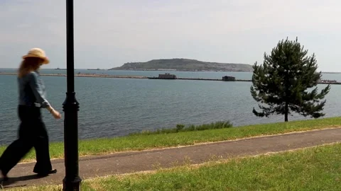 Lady walking on pathway with sea view nothe fort weymouth 스톡 동영상 137234712