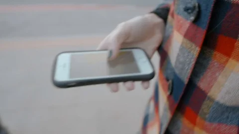 Lady is Walking on the road and Using the Navigation App on her Smartphone Stock Footage 74139864