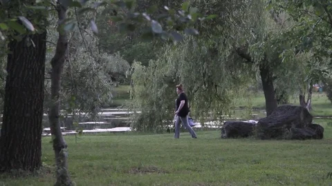 The lady walks into the park Video stock 77481258
