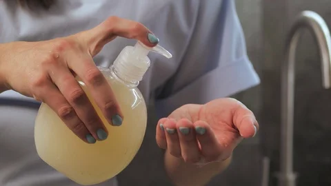 Lady washing up hands at bathroom, using soft gel for advanced skin care and Stock Footage 126855666