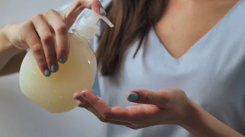 Lady washing up hands at bathroom, using soft gel for advanced skin care and pro Stock Footage 127405779