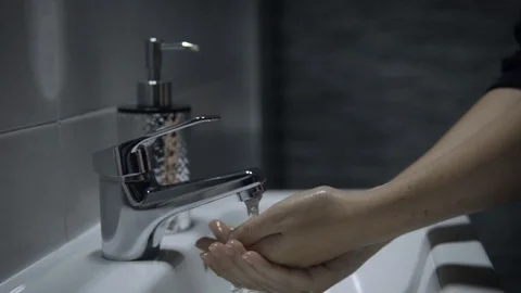 Lady washing hands with soap 库存影片 128496735