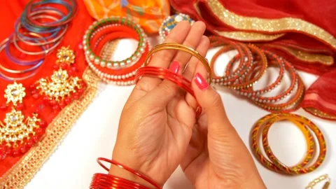 A lady wearing red bangles while getting ready to go out Stock Footage 163408051