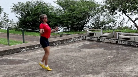 Lady Wearing a Red Blouse Jumping Rope Stock Footage 103159101