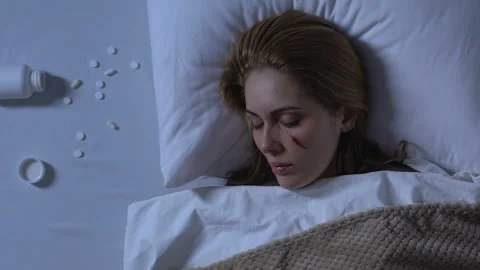 Lady with wounded face sleeping, pills spilling on bed, problems after trauma Stock Footage 106546718