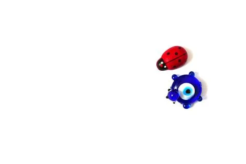 Ladybug and evil eye bead on a white background, close up ladybug, evil eye b Stock Photos