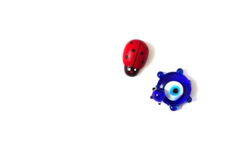 Ladybug and evil eye bead on a white background, close up ladybug, evil eye b Stock Photos