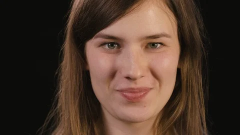 Lady's Face Against a Black Background Stock Footage 87188823