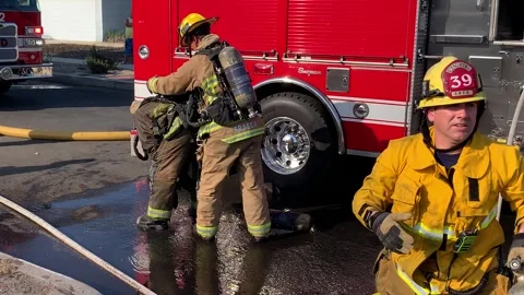 LAFD Firefighters Replace Oxygen Tank Breathing Apparatus for Fatigued Stock Footage 318702625